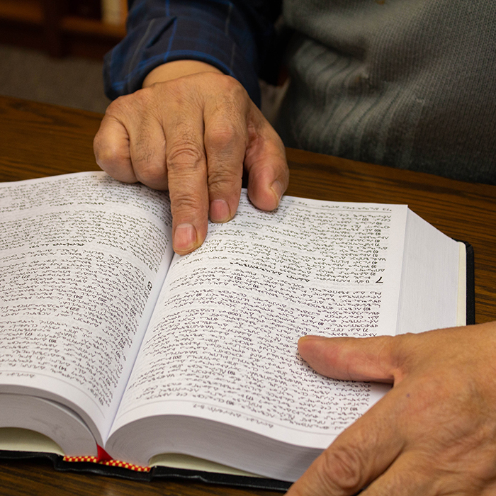 Hand on an open Bible